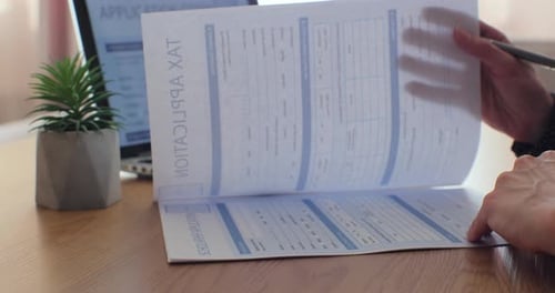 Woman Filling Tax Form Writing on Document