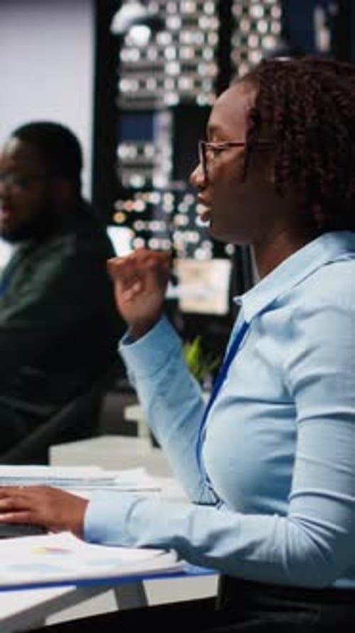 Vertical Video Black Woman Specialist Examine KPI Reports with Artificial Intelligence Tools