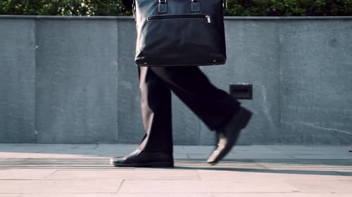 Side View of the Legs of a Businessman Driving to Work