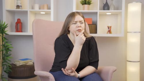 Thoughtful Woman Thinking in Armchair Indoors