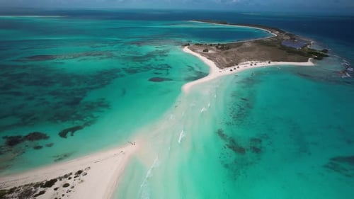 A tropical island with turquoise waters and sandy beaches, aerial view