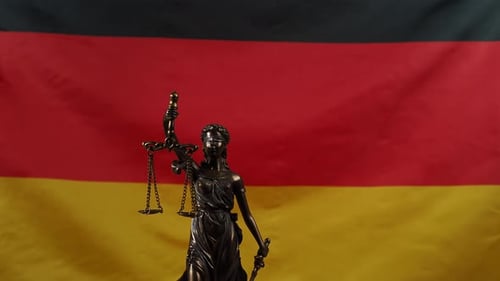 Lady Justice Statue Against German Flag