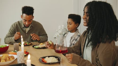 Family Meal With Candles at Dining Table