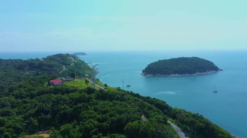 Aerial view of a wind turbine at Patong beach with blue turquois. Phuket