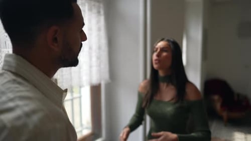 Young Couple Arguing Passionately Indoors During the Day