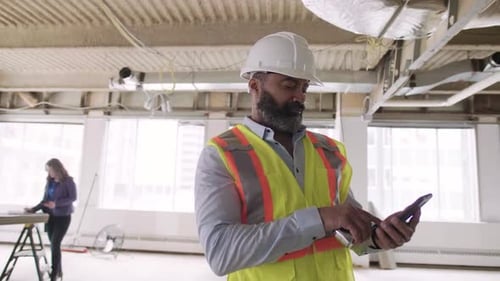 Of Construction Foreman on Phone in Empty Building