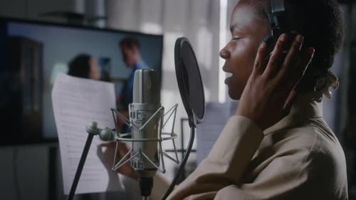Black Female Voice-Over Actress Dubbing Foreign Movie in Recording Studio