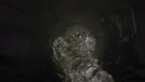 Liquid Pouring Inside Bottle Close Up