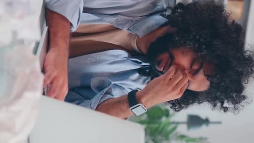 Young Adult Tired at Laptop Indoors During Day