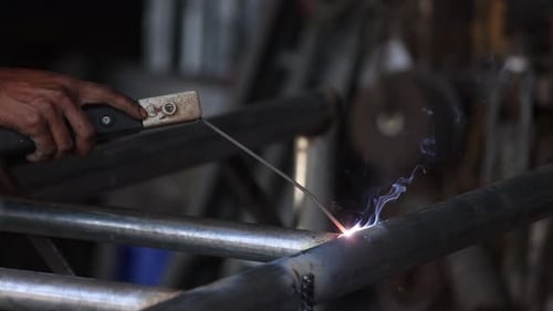 Welding Process at the Steel Factory Metalwork Manufacturing Maintenance Service Closeup on Hands