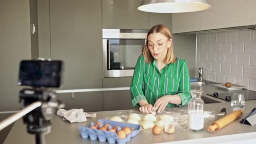 Woman Prepares Dough on Camera in Modern Kitchen