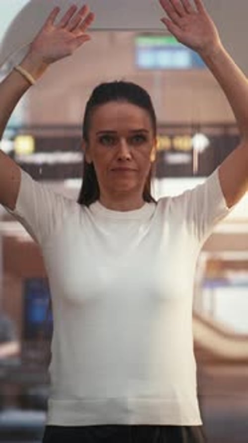 Young Woman Passing Electronic Security Search at Terminal Gate