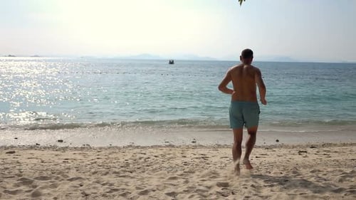 Young Man Running on Beach Into Sea, Super 240