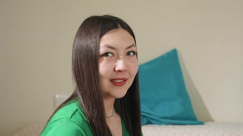 Smiling Young Woman with Brown Hair Indoors