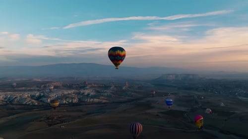 Scenic Hot Air Balloons Over Rocky Landscape at Sunrise