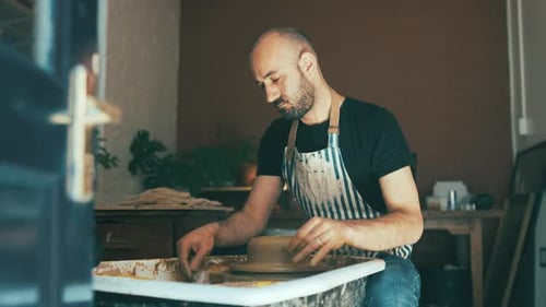 Artist, ceramics and pottery studio with worker, craftsmanship and clay in artist workshop