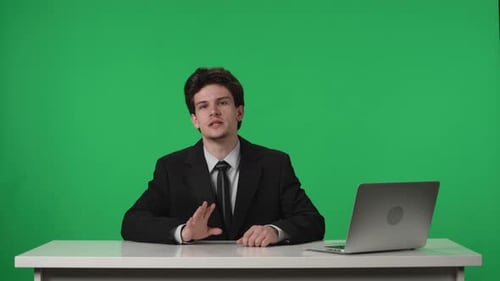 Man Presenting at Desk on Green Screen