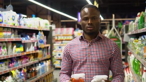 Man Shopping for Cleaning Products in a Supermarket