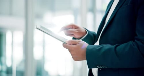 Hands, typing and man in office with tablet, scroll and checking online business review