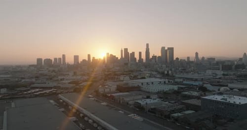 a city with buildings and a sunset