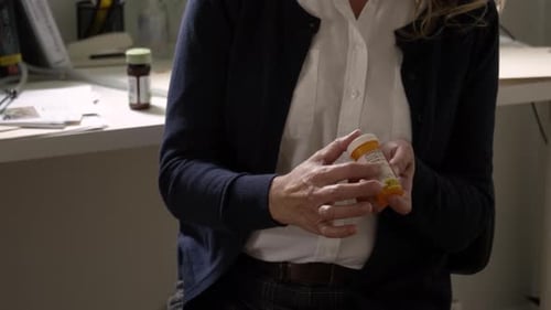 Woman Reads Prescription Label, Health and Wellness Concept