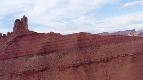 Drone rotates at top of the red stone mountains capturing the area of butte, Utah, United States.