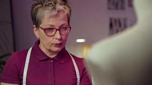 Fashion Designer Working on Garment on Dress Form