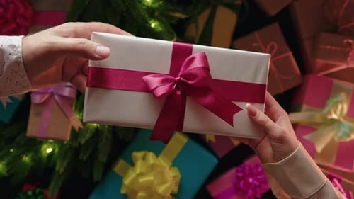 Man Gives Christmas Present to Woman Overhead View