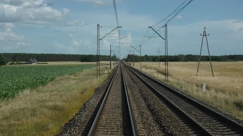 View From Moving Train Onto Railway Track with Road Crossing