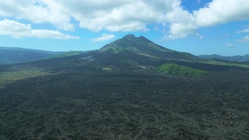 Glamping on the Green Hill at Batur Volcano Background with Black Lava in Kintamani Bali Indonesia