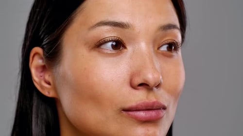 Woman Applying Makeup with Brush in Close Up