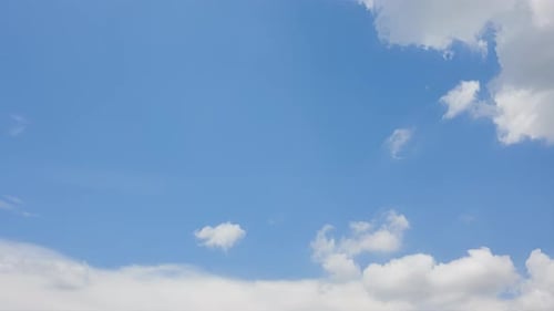 Clouds Float Peacefully Across Blue Sky During the Day