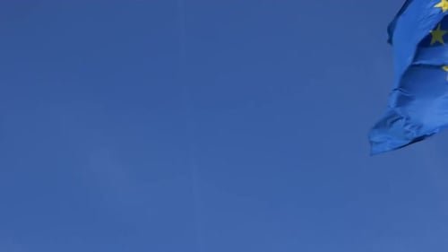 European Union Flag Waving Gently in Blue Sky