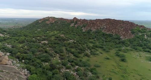 Aerial View, Forward shot, Green lush bush's and scrubs in between the mountains - Beautiful scenic