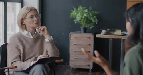 Thoughtful Therapist Listening to Patient During Therapy Session