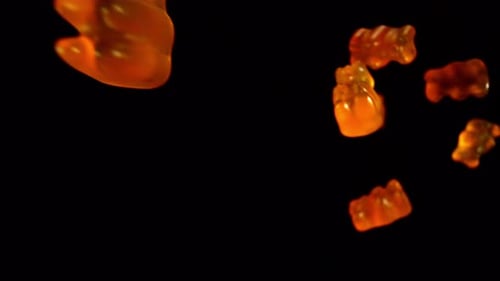 Gummy Bears Falling on a Black Background