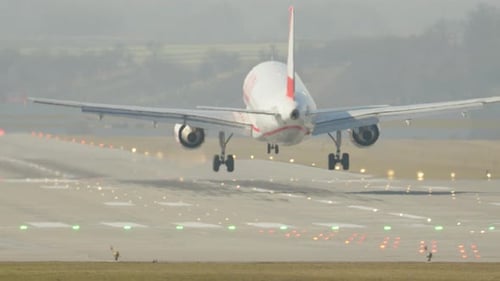 Aircraft landing on runway during a clear afternoon approach
