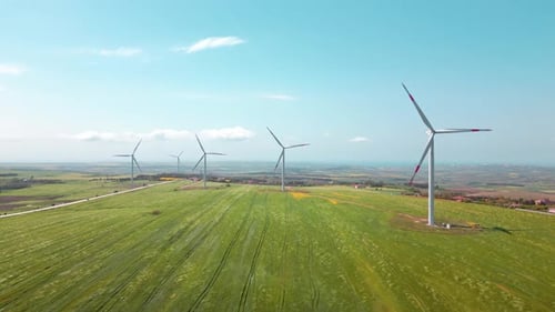 Wind Turbines Spinning in a Green Rural Landscape
