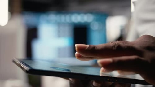 African American Developer Evaluating 3D Models Blueprints and Digital Software