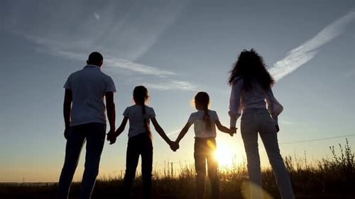 Happy Family Raise Hands Up Overlooking Setting Sun