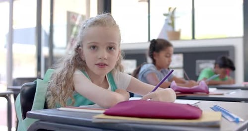 Caucasian girl studying in a school classroom