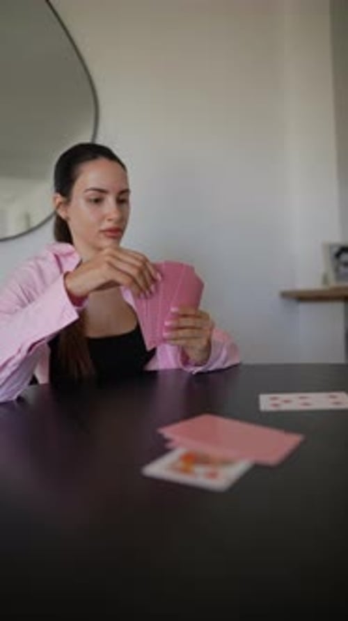 Group of Young Women Playing Cards at Stylish Table Fostering Friendship in Modern Room