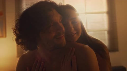 Loving Couple Embrace at Sunrise Indoors