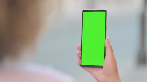 Outdoor Young African Woman Using Phone with Green Screen