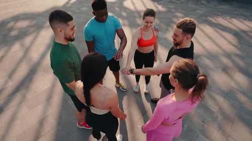 Friends Join Hands in Urban Fitness Circle