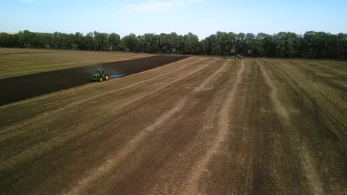 Tractors plowing the field in Ukraine