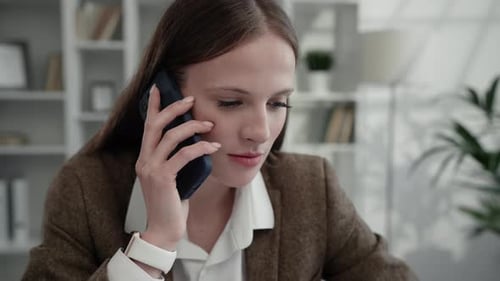 Young Woman Talking on Phone in Office