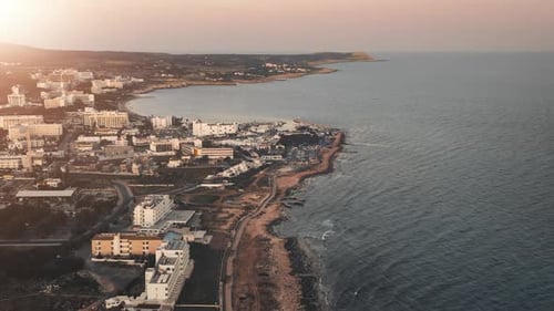 Aerial Pink Dawn Over City Houses By Blue Sea Sun Scorched Coastline Island Summer Vacation on Bay