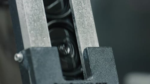 Aluminum cans moving on conveyor belt in factory