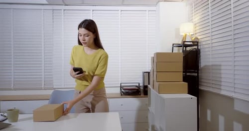 Young Woman Scanning Package in a Bright Office